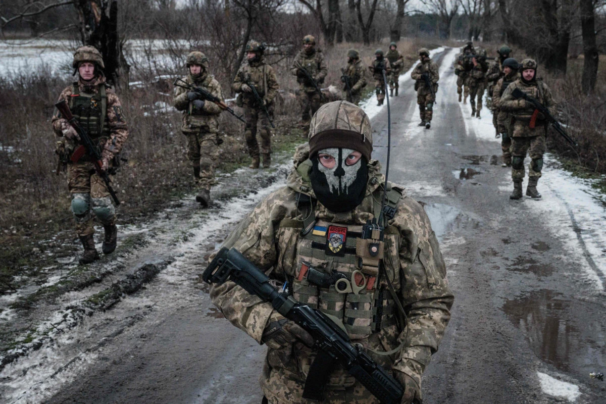Ukrainian servicemen walk on the road toward their base near the frontline in the Donetsk region on February 4, 2023, amid the Russian invasion of Ukraine. (AFP)