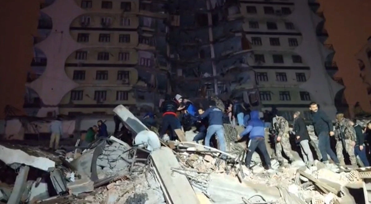 In this video grab from AFP TV taken on Feb. 6, 2023, rescuers search for victims of a 7.8-magnitude earthquake that hit Diyarbakir, in southeastern Turkey. (AFPTV / AFP)