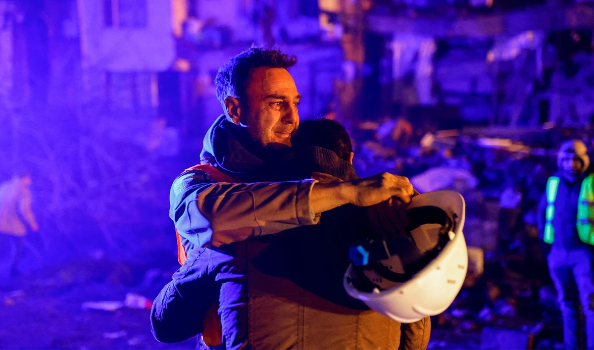 Volunteers share an emotional moment as they take part in a rescue operation following an earthquake in Hatay, Turkey on February 8, 2023. (REUTERS)