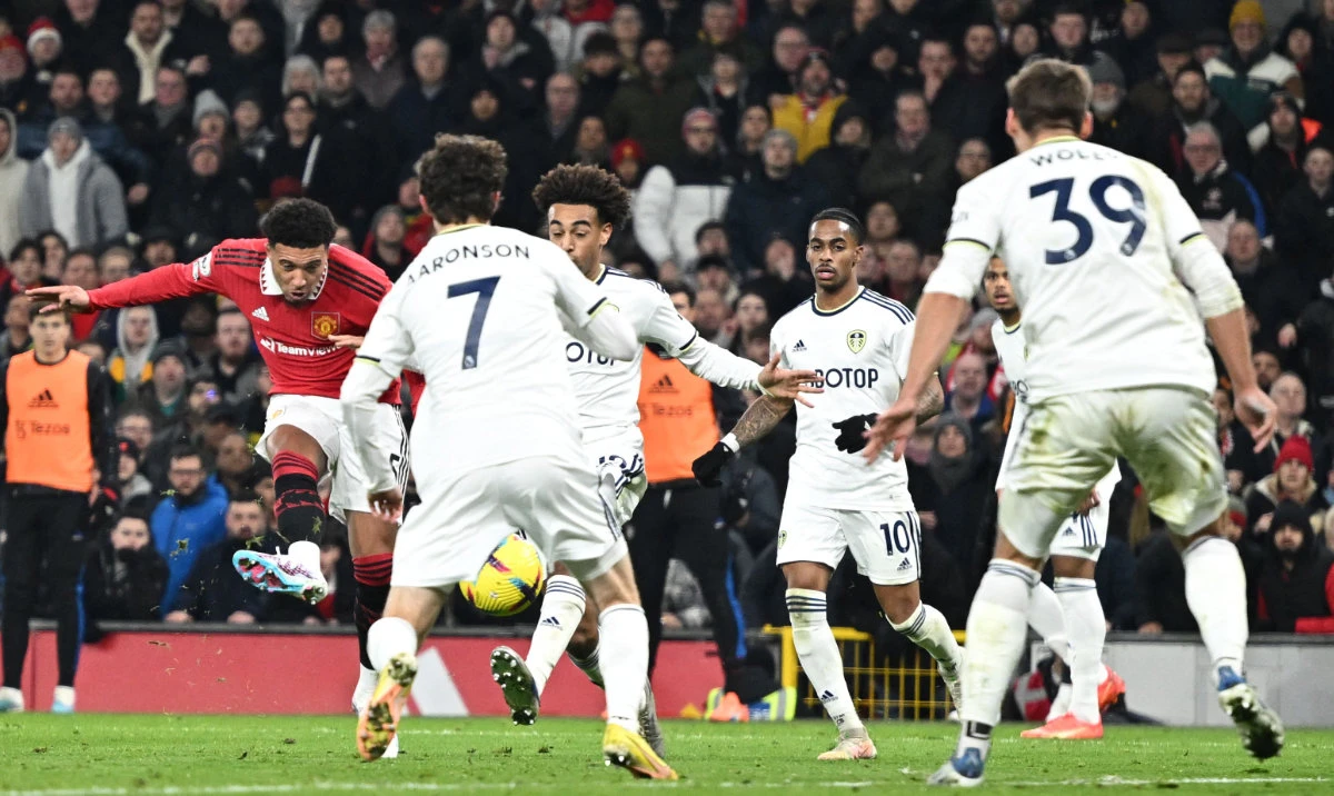 Manchester United's English striker Jadon Sancho (L) shoots and scores his team's second goal during their Premier League football match against Leeds United at Old Trafford in Manchester, north west England, on Wednesday. (AFP)