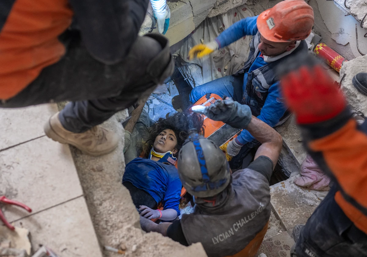 Emergency personnel conduct a rescue operation to save 16-year-old Melda from the rubble of a collapsed building in Hatay, southern Turkey. (AFP)