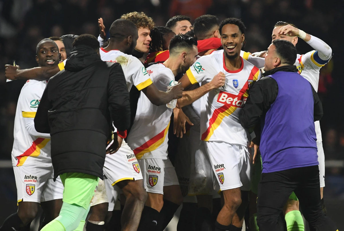 Lens players celebrate at the end of their round of 16 French Cup football match against FC Lorient at THe Moustoir Stadium in Lorient, western France on Feb 9, 2023. (AFP)