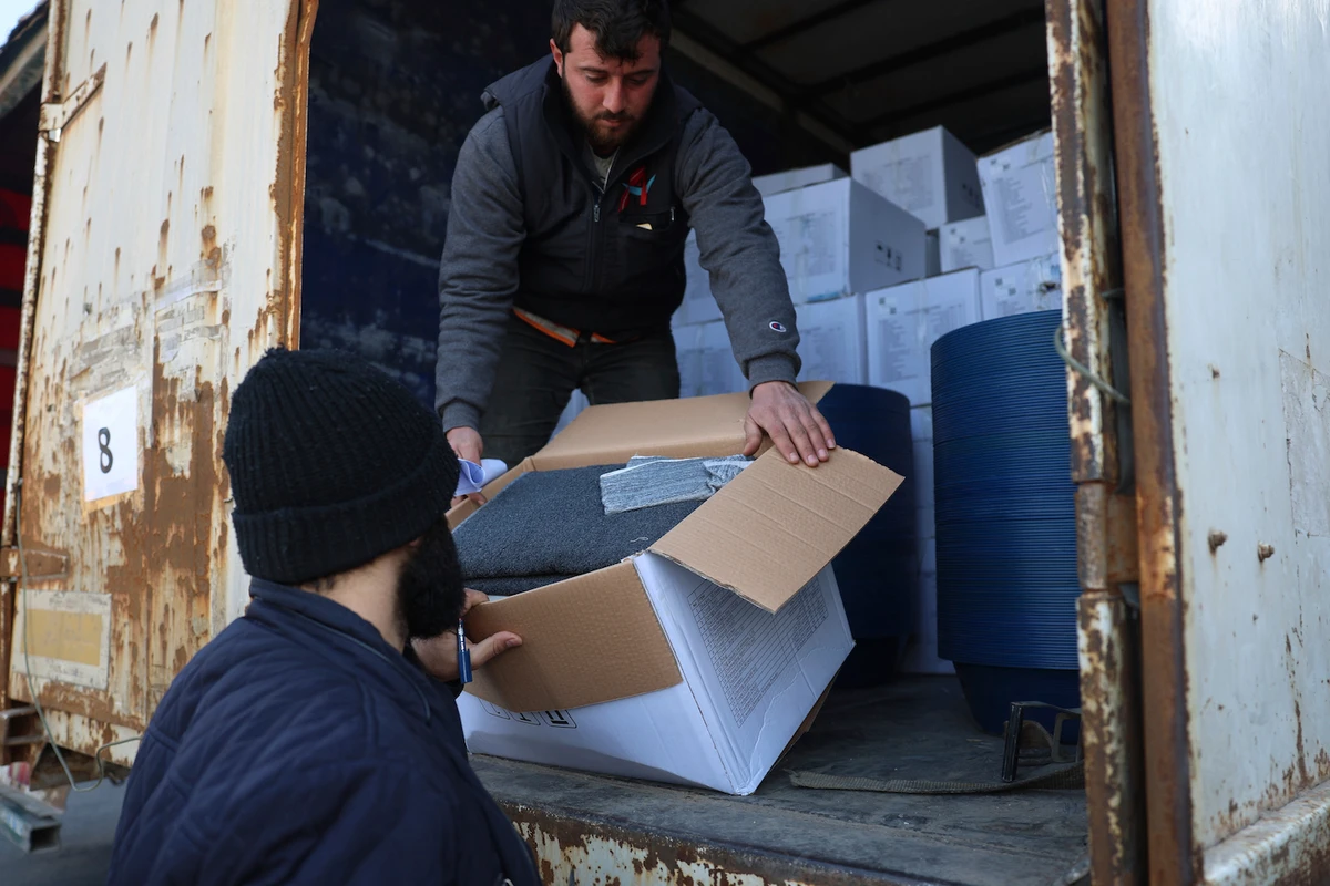 Border customs officials inspect a truck loaded with UN humanitarian aid for Syria at the Bab Al-Hawa border crossing with Turkey, Idlib province, Syria. (File/AFP)