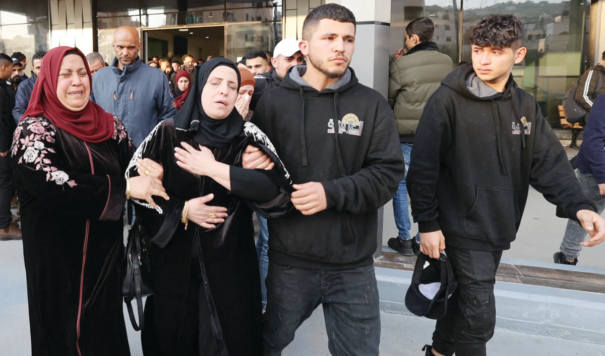 The mother and relatives of a young Palestinian boy react on Sunday after he was reportedly shot dead by Israeli forces during confrontations in the West Bank town of Jenin. (AFP/File)