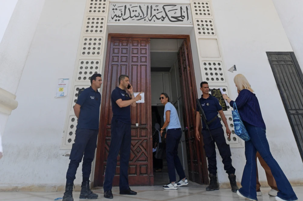 Police officers stand at the entrance to the Ariana tribunal near the Tunisian capital Tunis on June 6, 2022, after judges launched a week-long strike in protest at President Kais Saied's "interference" in the judiciary. (AFP)