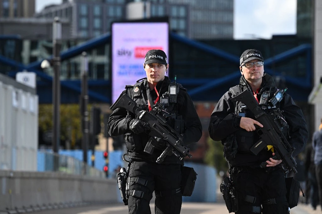 Armed police patrol in London (AFP)