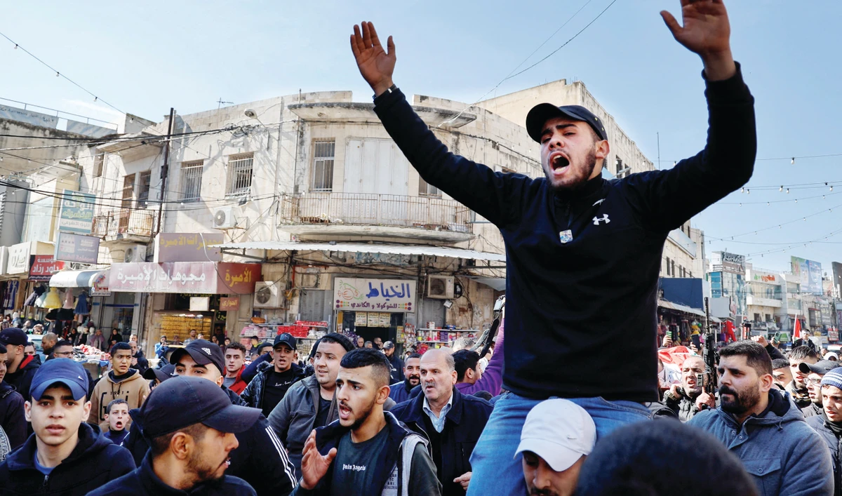 Mourners attend the funeral of 21-year-old Palestinian Amir Ihab Bustami in Nablus in the Israeli-occupied West Bank on Monday. He was killed in an Israeli army raid. (Reuters)