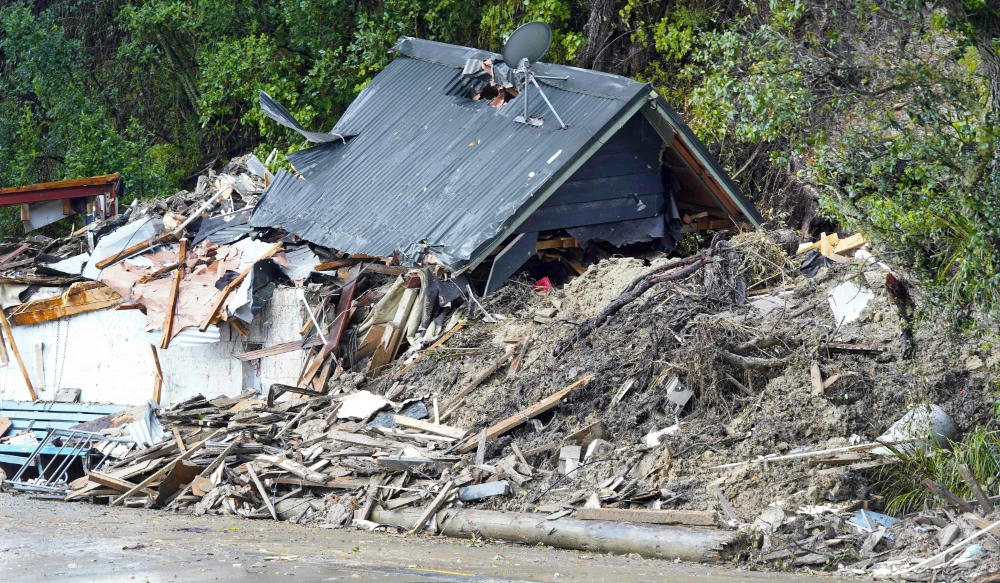 A general view of a damaged house after a storm battered Titirangi, a suburb of New Zealand's West Auckland area, on February 13, 2023. (AFP)