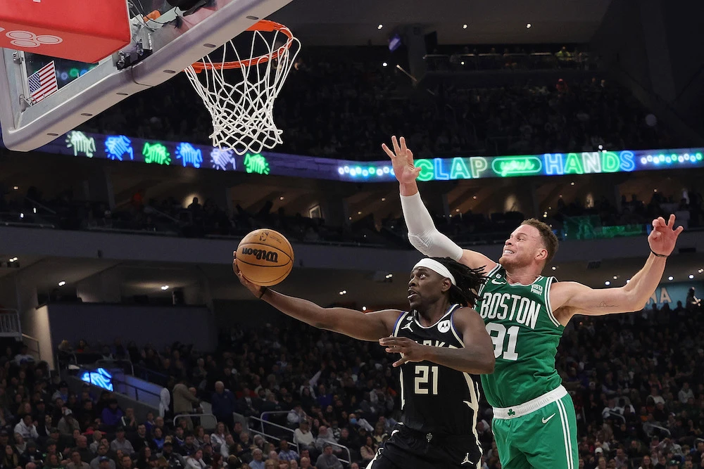 Jrue Holiday of the Milwaukee Bucks drives to the basket against Blake Griffin of the Boston Celtics during the first half of an NBA game at Fiserv Forum on Tuesday in Milwaukee, Wisconsin.(AFP)