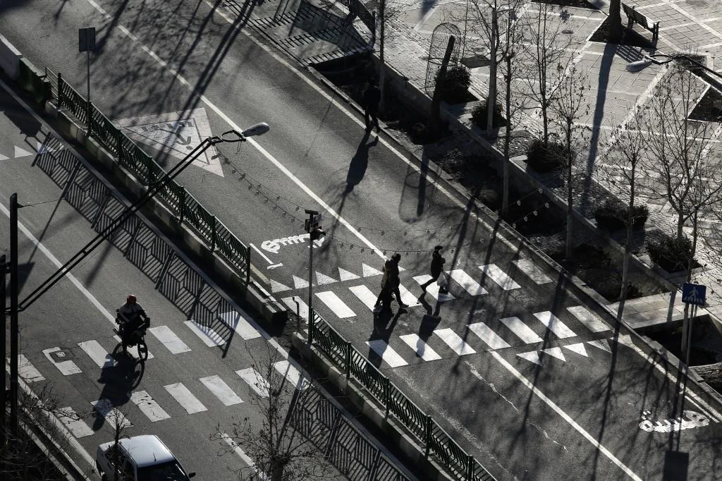 Iranians walk in a street in the capital Tehran on Jan. 7, 2023. (AFP)