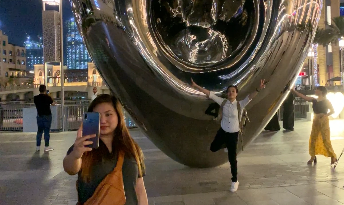 Young Filipinos take photos at a recreational area near Burj Khalifa, Dubai, the United Arab Emirates, in July 2019. (AN Photo)