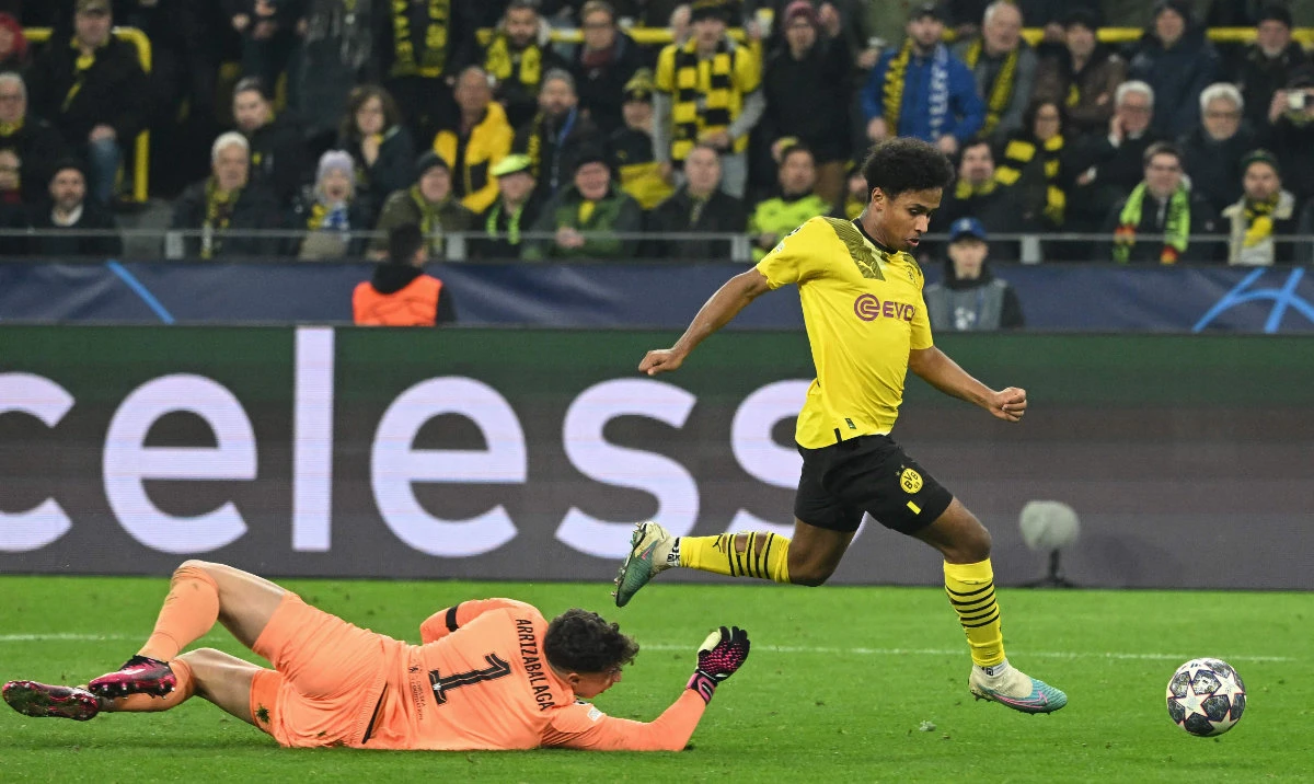 Dortmund's German forward Karim Adeyemi goes past Chelsea's Spanish goalkeeper Kepa Arrizabalaga to score the opening goal during their UEFA Champions League first leg round of 16 football match in Dortmund, western Germany, on Wednesday. (AFP)