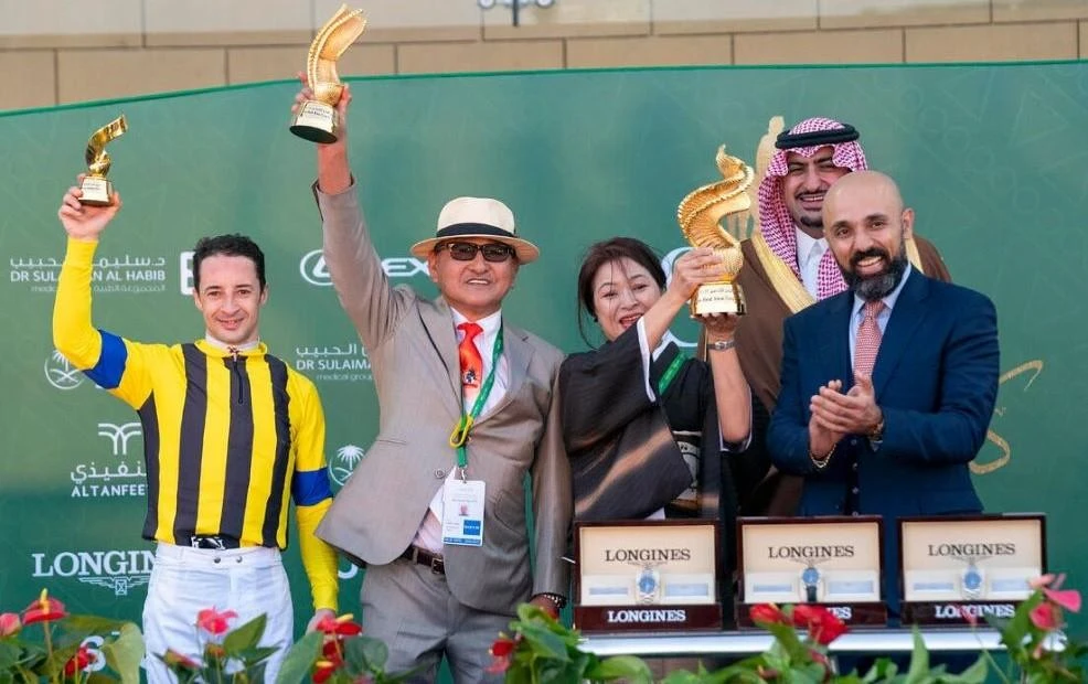 Christophe Lemaire, left, and Yoshito Yahagi, 2nd left, celebrate winning the G3 Longines Red Sea Turf Handicap in 2022. (JCSA/Mathea Kelley)