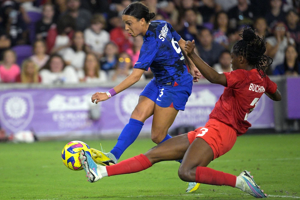 US forward Mallory Swanson (9) attempts a shot on goal as Canada's Kadeisha Buchanan defends during the second half of a SheBelieves Cup soccer match Thursday in Orlando, Fla. (AP)