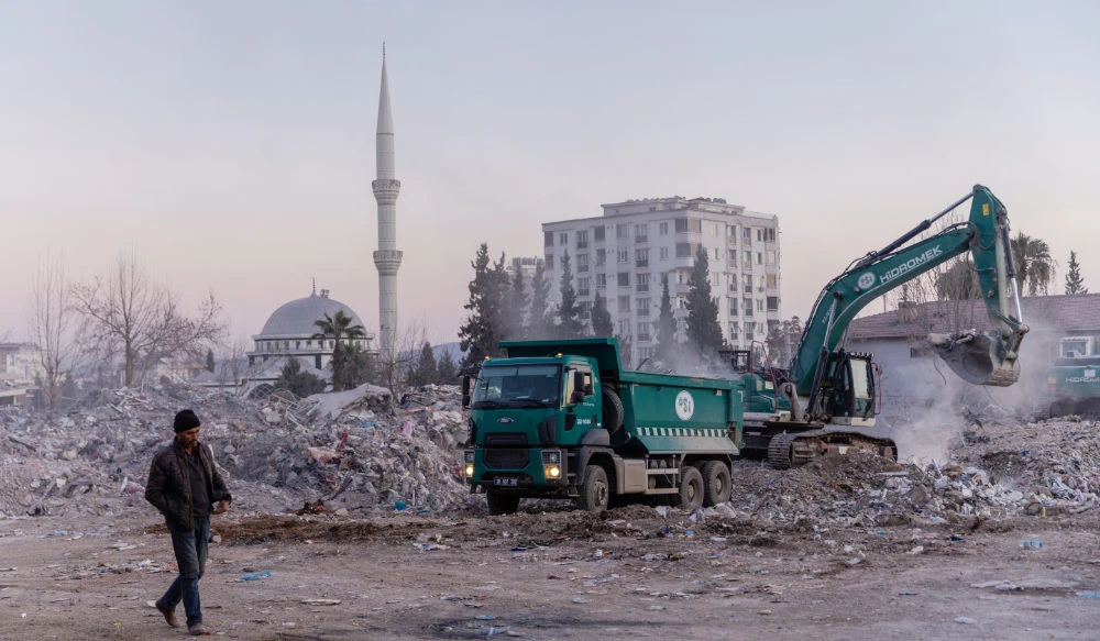 A man walks next to a demolition site with a mosque in the background in the aftermath of a deadly earthquake in Kahramanmaras, Turkey, February 17, 2023. (REUTERS)