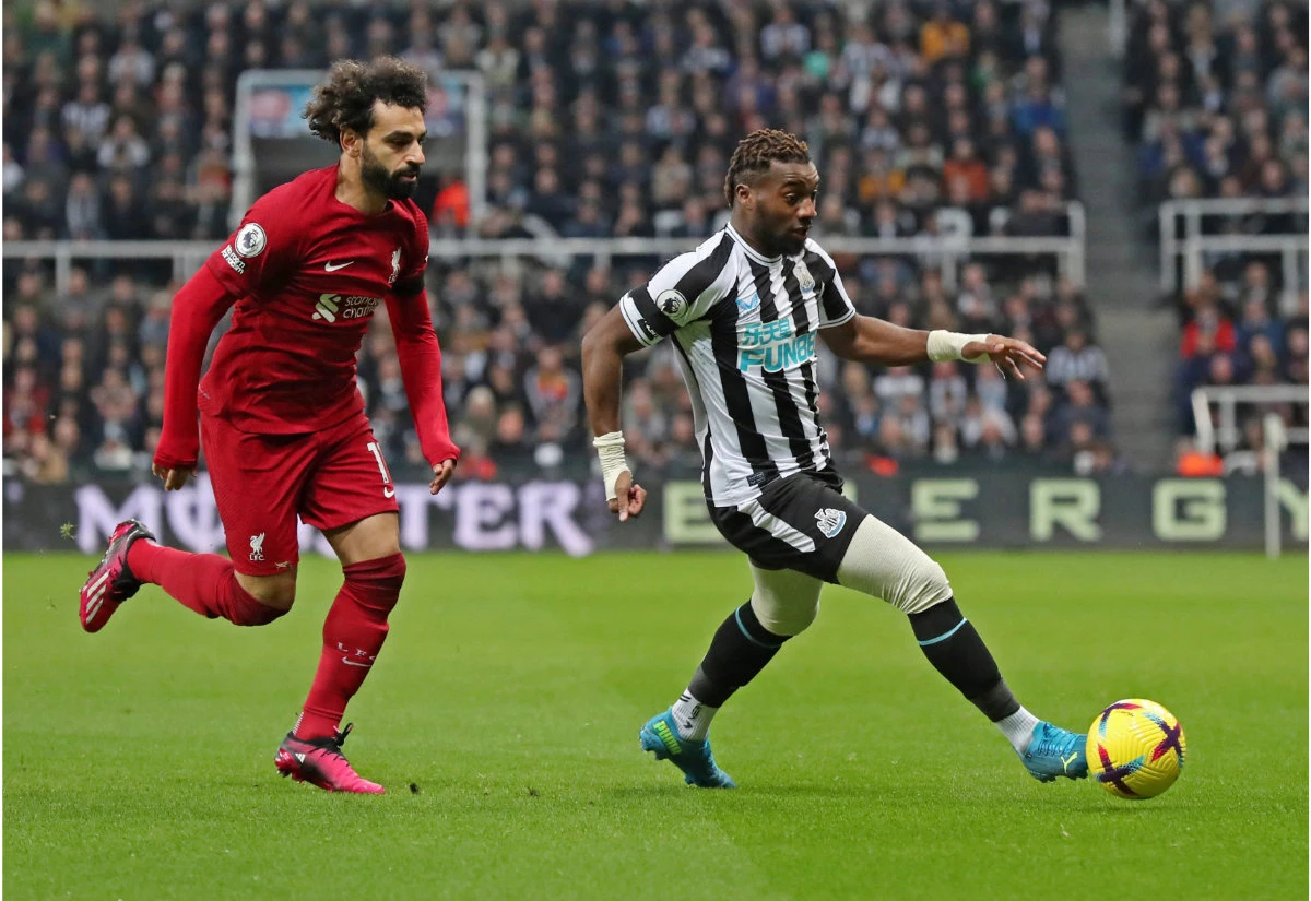 Newcastle United’s Allan Saint-Maximin in action with Liverpool’s Mohamed Salah during Saturday’s Premier League match at St. James’ Park in England. (Reuters)