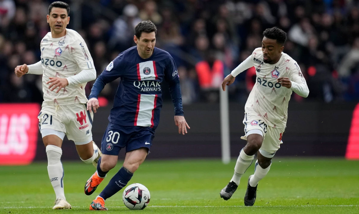 PSG's Lionel Messi, centre, dribbles past Lille's Benjamin Andre, left, and Lille's Timothy Weah during the French League One soccer match between Paris Saint-Germain and Lille at the Parc des Princes stadium, in Paris, France, Sunday, Feb. 19, 2023. (AP)