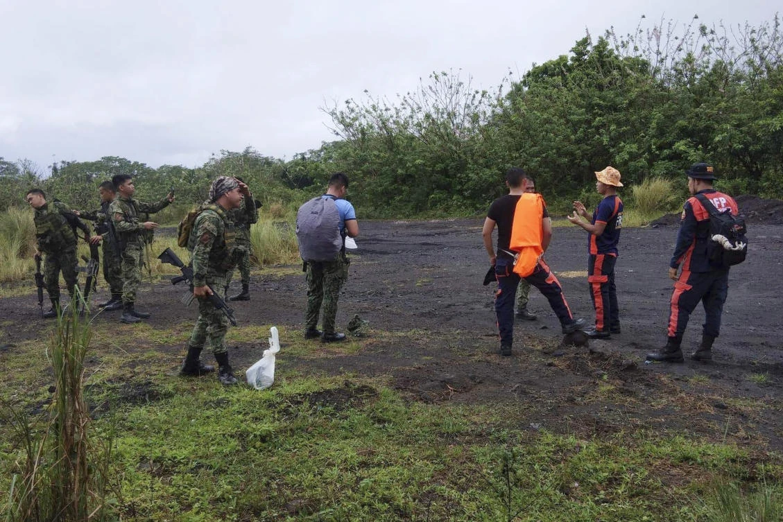 Rescuers prepare to search for passengers of a Cessna 340 aircraft with registry number RP-C2080 at Tumpa Gulley, Camalig town of Albay province on Monday Feb. 20, 2023. (Bureau of Fire Protection Camalig via AP)