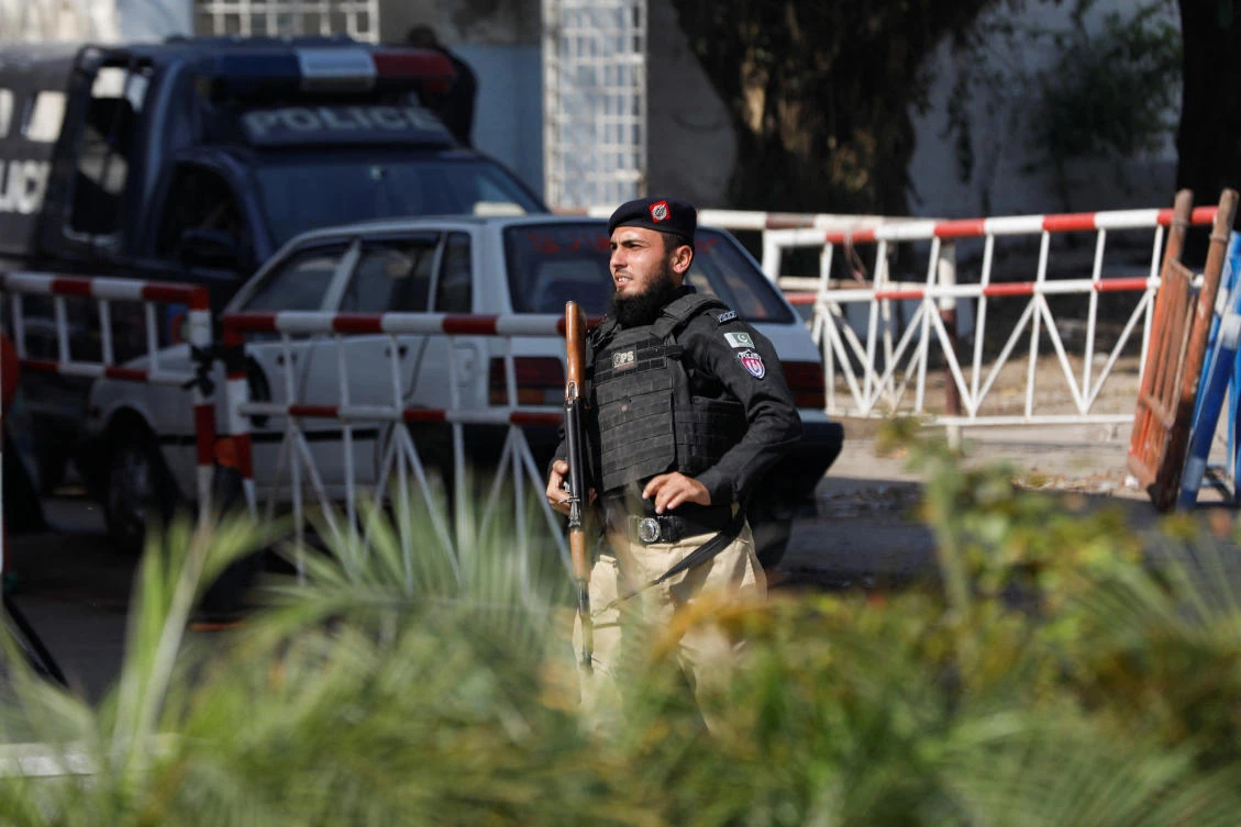 A police officer guards the route leading to the building after yesterday's attack on a police station, in Karachi, Pakistan February 18, 2023. (REUTERS)