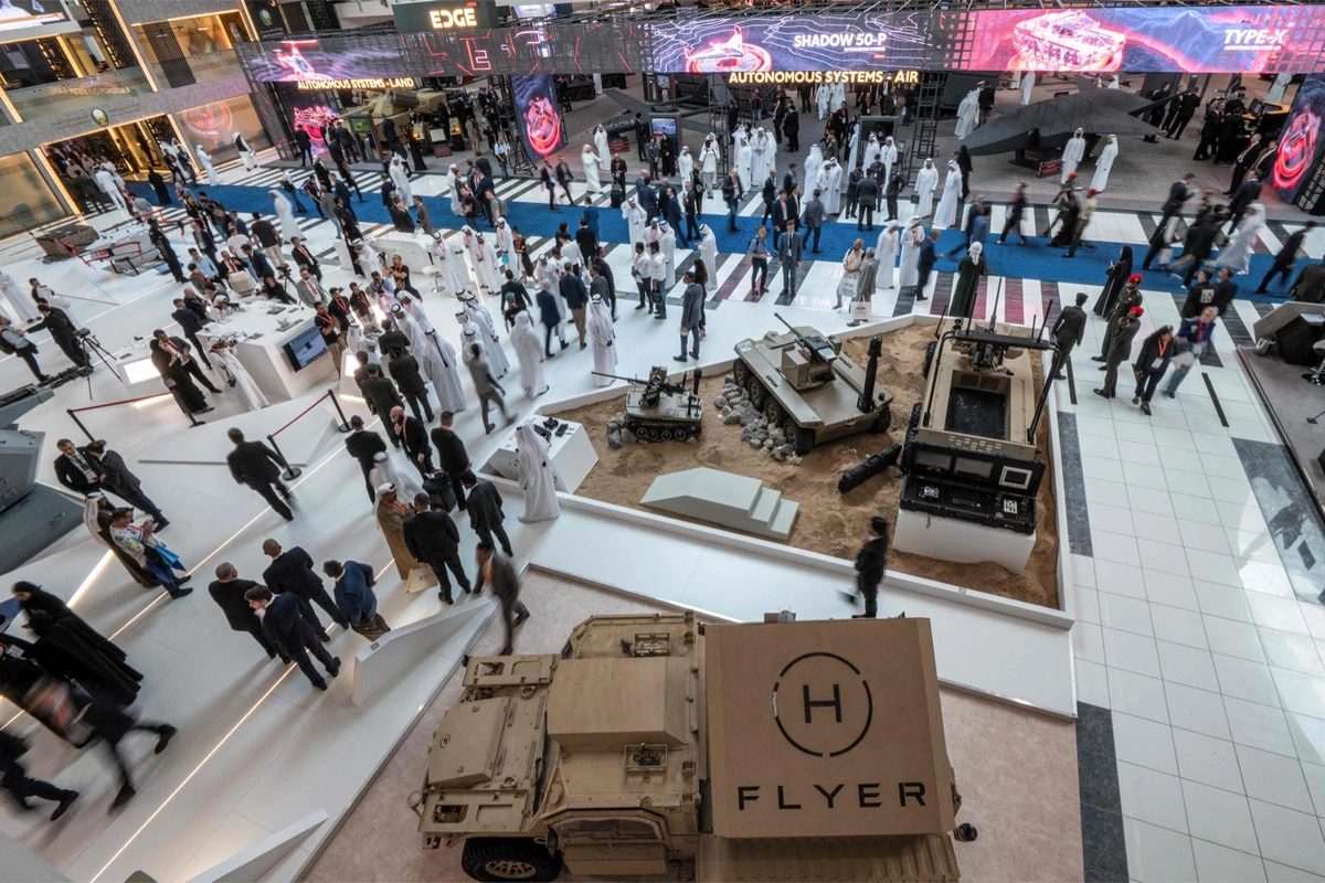 Visitors tour past unmanned aerial and ground combat vehicles at the EDGE pavilion during the International Defense Exhibition at the Abu Dhabi International Exhibition Center on Monday.AFP