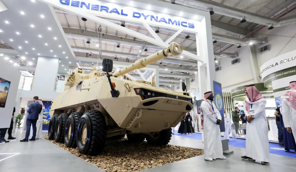 Saudi men are seen at General Dynamics stand displaying the latest defence system at World Defense Show in Riyadh, Saudi Arabia. (REUTERS)