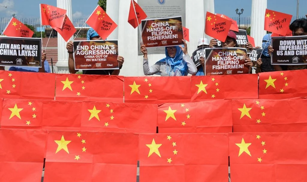 Above, activists in Manila protest China’s presence in the disputed South China Sea. (AFP)