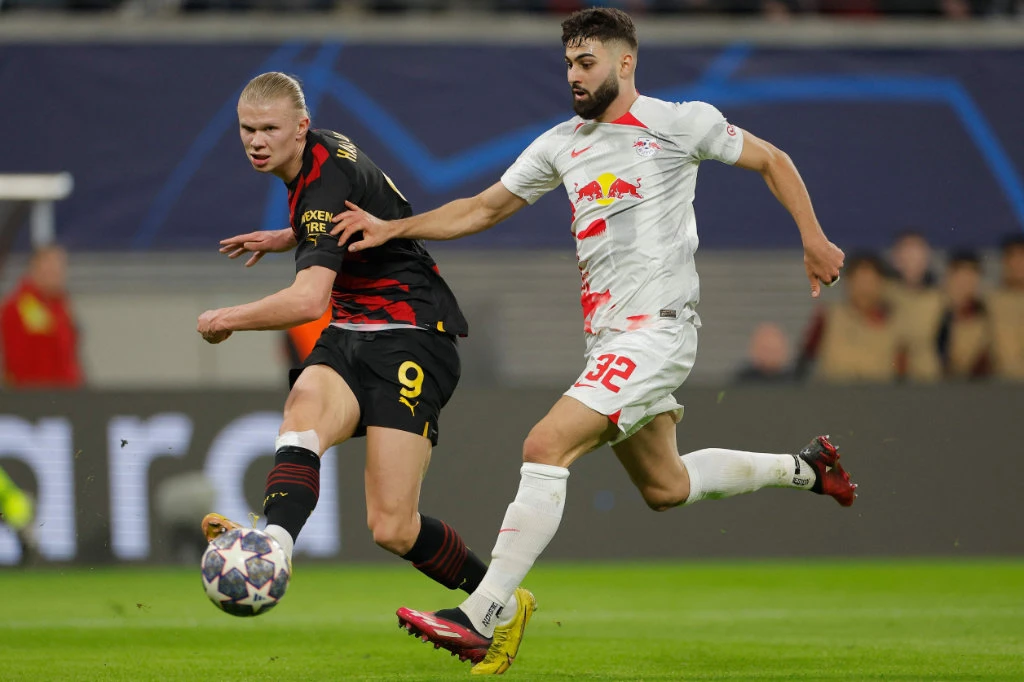 Manchester City's Norwegian striker Erling Haaland (L) gets a shot away past Leipzig's Croatian defender Josko Gvardiol during the UEFA Champions League round of 16, first-leg football match between RB Leipzig and Manchester City in Leipzig, eastern Germany on February 22, 2023. (AFP)