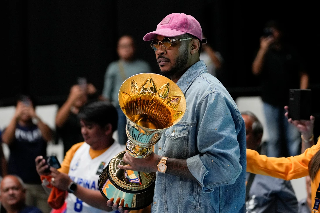 FIBA Global Ambassador Carmelo Anthony carries a trophy before the game between Philippines and Lebanon at the FIBA Basketball World Cup 2023 Asian Qualifiers at the Philippine Arena in Bulacan province, north of Manila. (AP)
