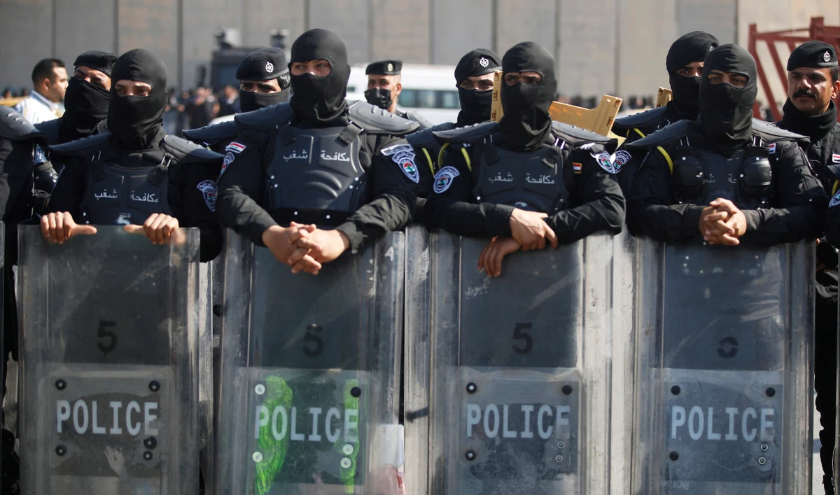 Iraqi security members during a protest near Baghdad's Green Zone on February 27, 2023 as the Iraqi Parliament convenes to amend the electoral law for governorate councils. (AFP)