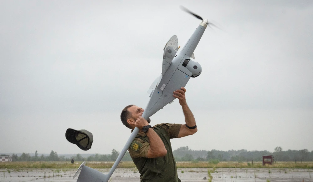 A Ukrainian soldier launches FlyEye WB Electronics SA, a Polish reconnaissance drone, which is in service with the Ukrainian army, in Kyiv region, Ukraine, Tuesday, Aug. 2, 2022. (AP)