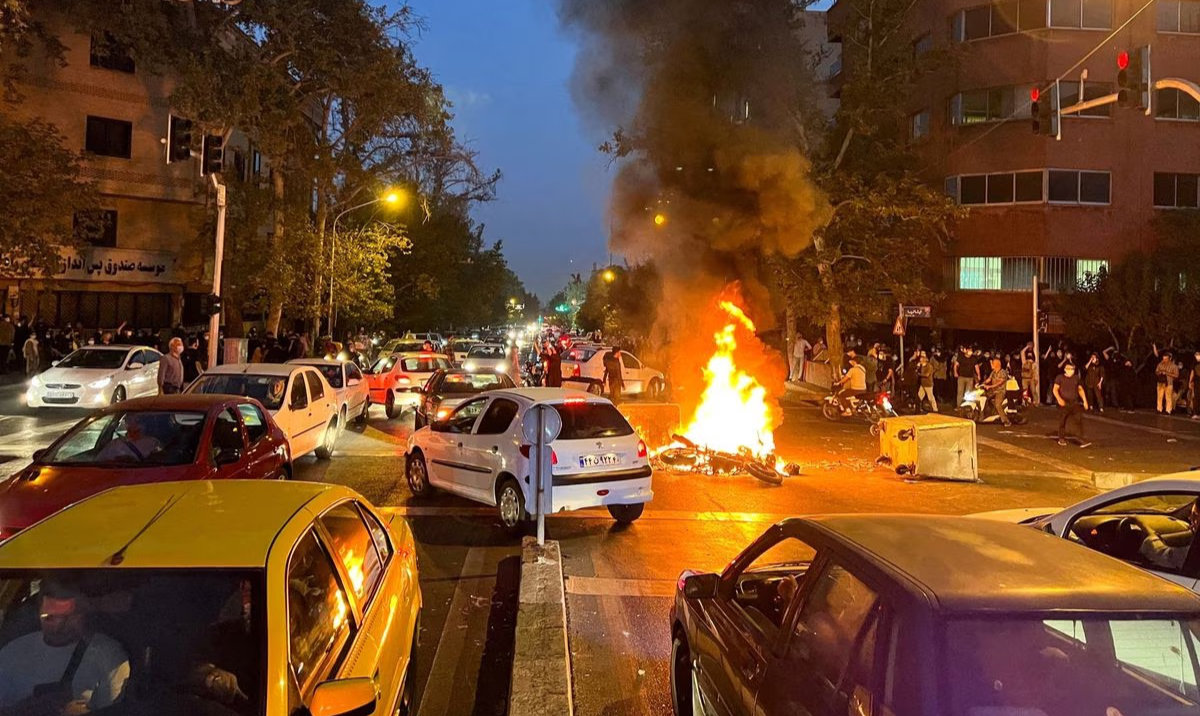 A police motorcycle burns during a protest in Tehran, Iran. (Reuters/File)