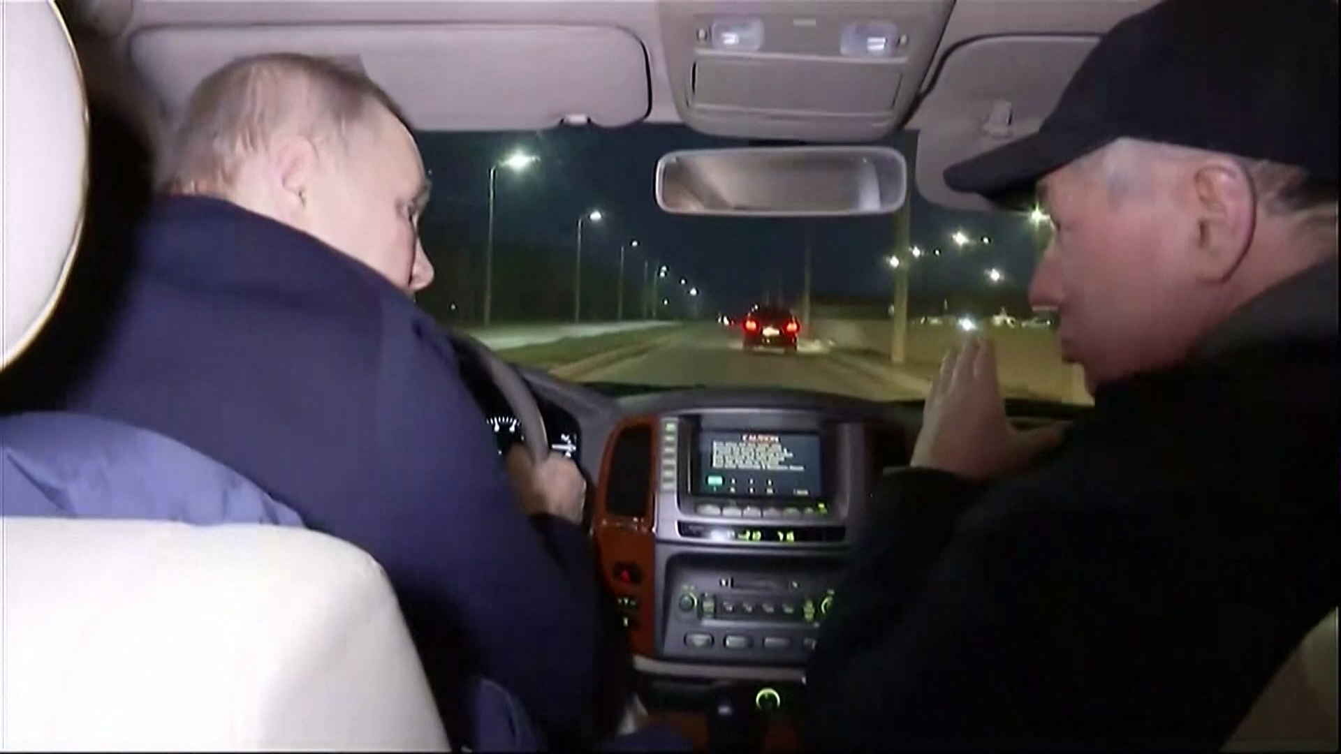 Russia's Vladimir Putin (L) driving with Deputy Prime Minister Marat Khusnullin as he visits Mariupol March 18, 2023. (AFP)