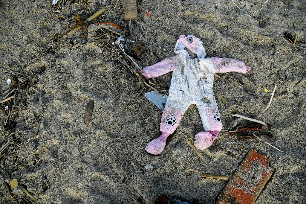 a onesie washed up on the beach, two days after a boat of migrants sank off Italy's southern Calabria region, in Steccato di Cutro, south of Crotone.(AFP)