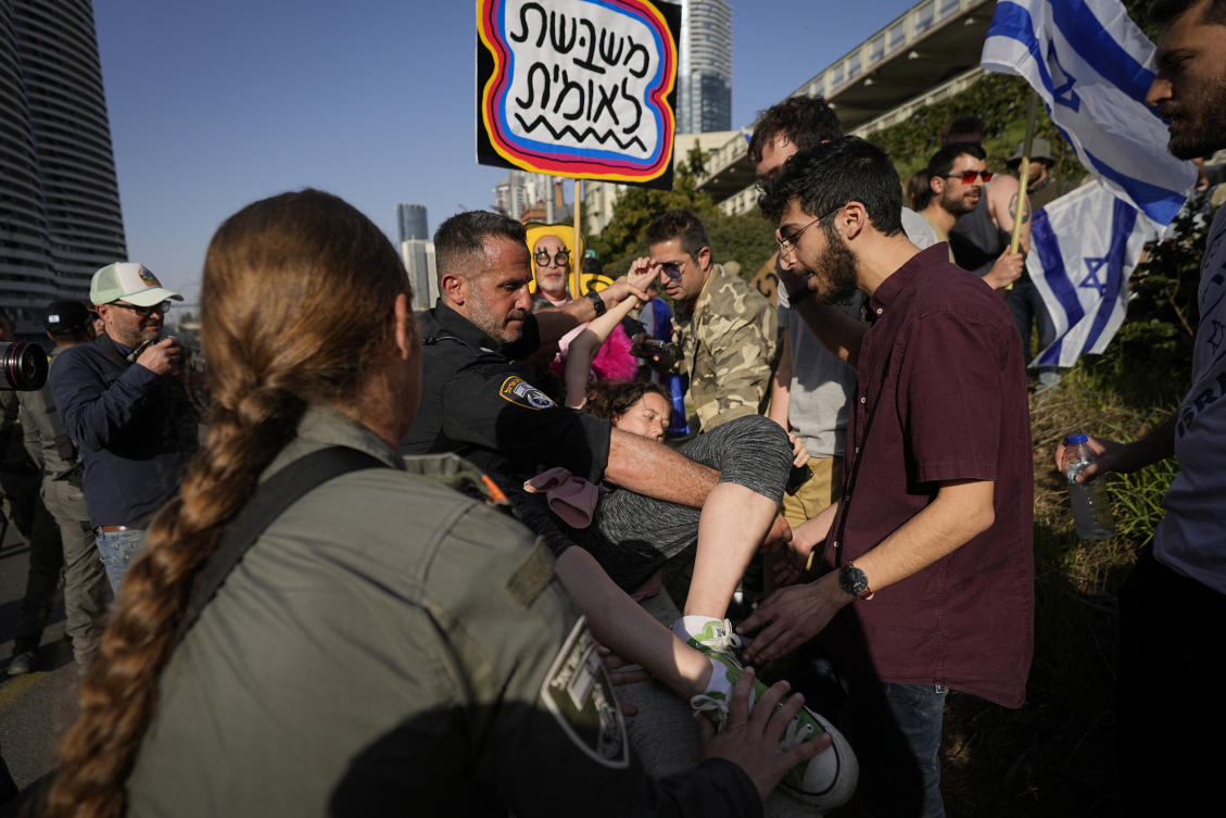 Israeli police scuffle with protesters as they try to block a main road to protest against plans by Prime Minister Benjamin Netanyahu's new government to overhaul the judicial system, in Tel Aviv, Israel, Wednesday, March 1, 2023. (AP)