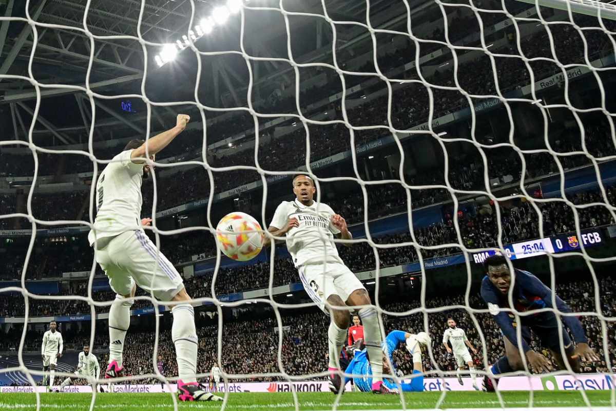 Real Madrid's Brazilian defender Eder Militao (C) reacts after scoring an own-goal next to Barcelona's Ivorian midfielder Franck Kessie (R) during their Copa del Rey (King's Cup) semifinal first leg at the Santiago Bernabeu stadium in Madrid on March 2, 2023. (AFP)