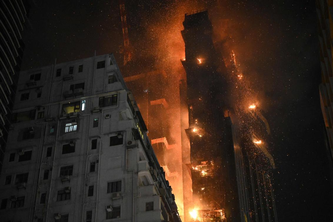A fire burns at a high-rise building under construction in the Tsim Sha Tsui district in Hong Kong (AFP)