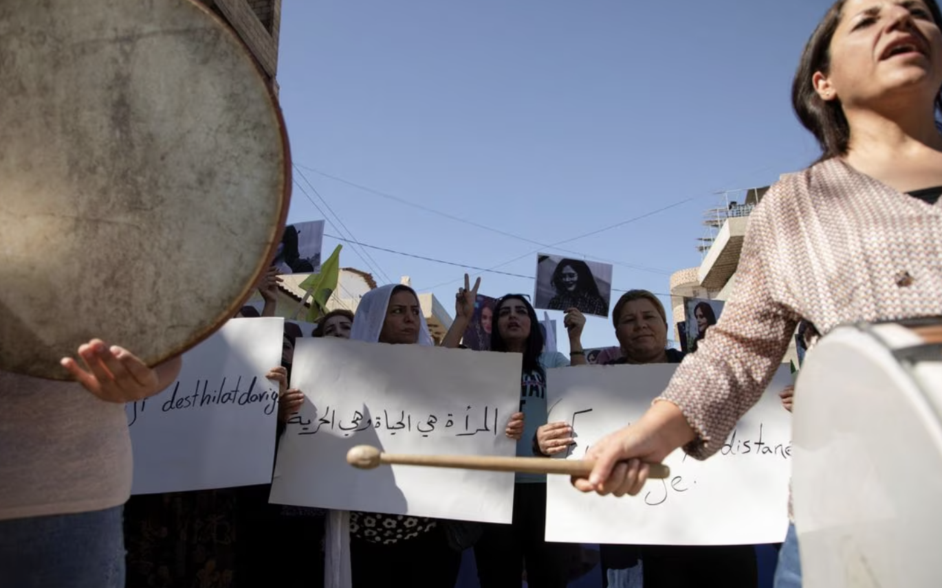 Women carry banners and play instruments during a protest over the death of 22-year-old Kurdish woman Mahsa Amini in Iran. (Reuters/File Photo)