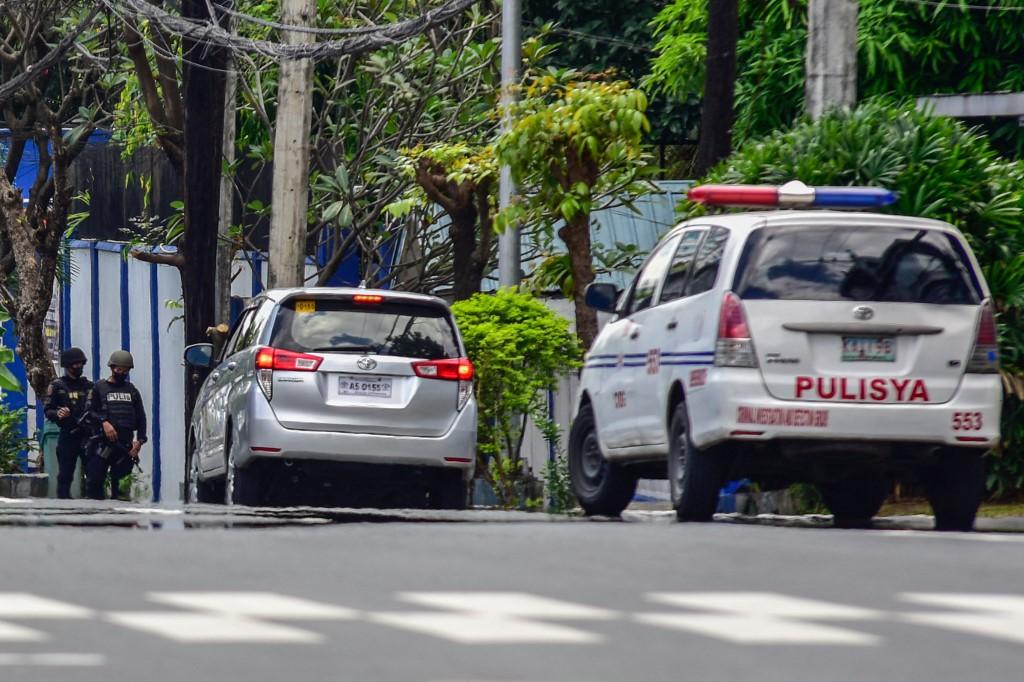 This picture shows police outside the Philippine National Police Custodial Center at Camp Crame in Quezon City, suburban Manila on October 9, 2022. (AFP)