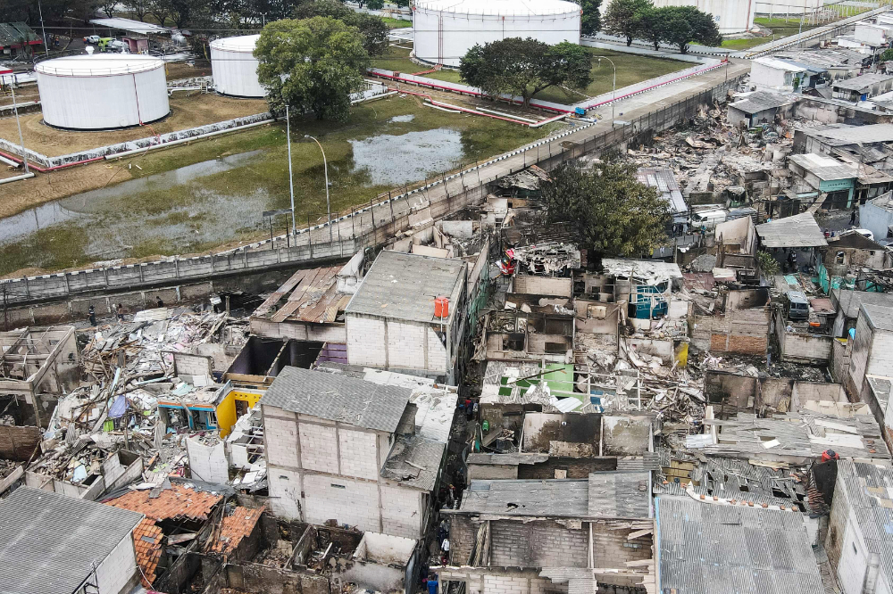 This aerial picture shows burnt houses in a residential area in Plumpang, north Jakarta on March 4, 2023, after a fire at a nearby state-run fuel storage depot run by energy firm Pertamina. (AFP)