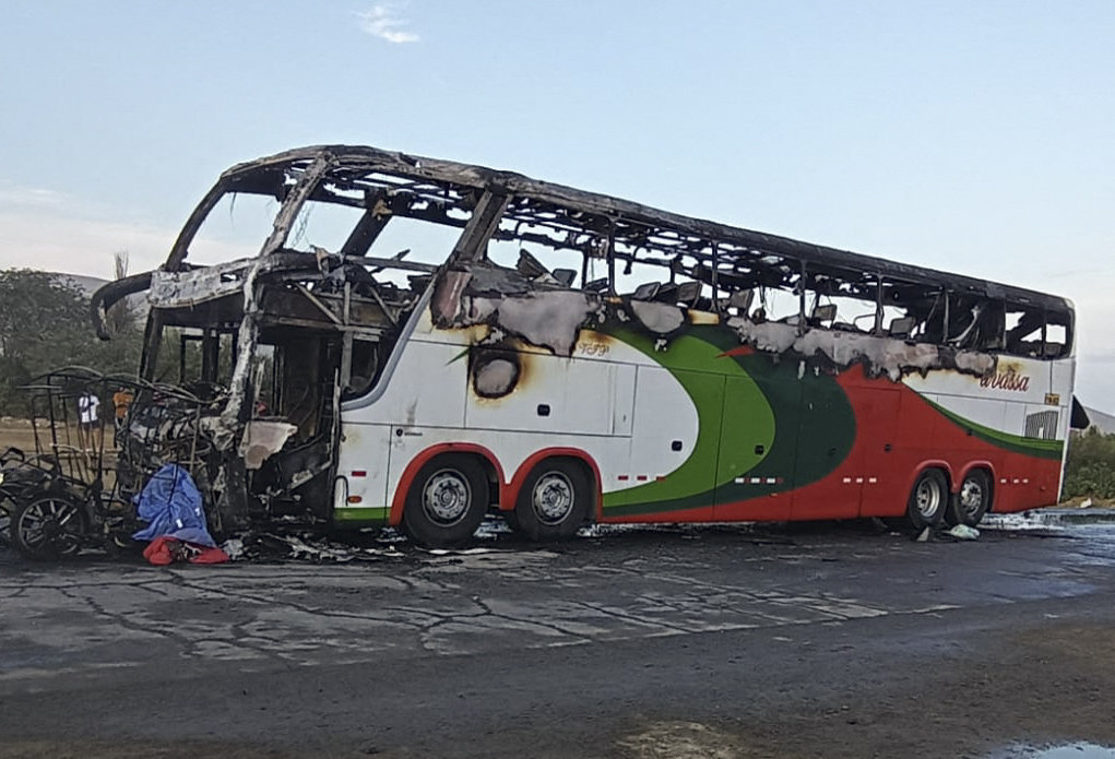 The remains of a bus and a moto taxi that caught fire after a head-on collision in Peru's Pan-American road crossing in the town of Casma on March 5, 2023. (Red Chimbote News Handout via AFP)