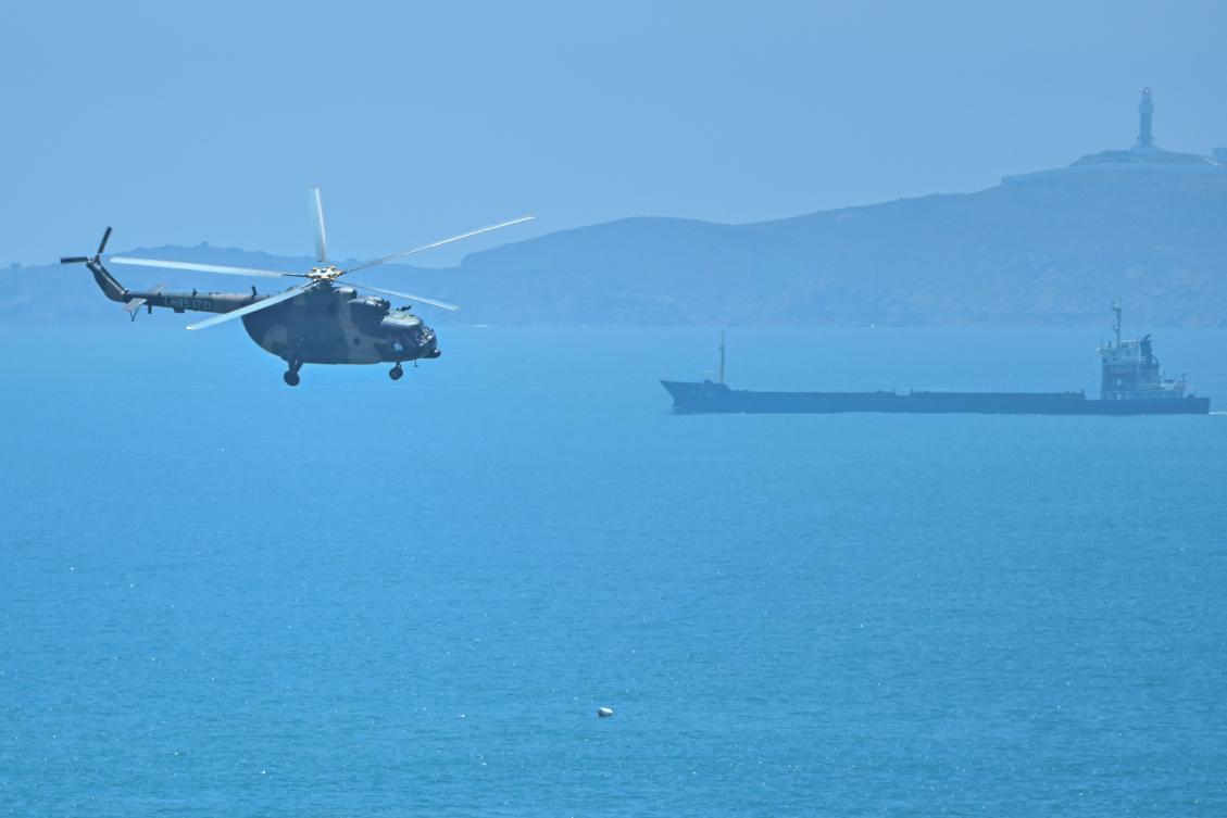 A Chinese military helicopter flies past Pingtan island, one of mainland China’s closest point from Taiwan, in Fujian province on Aug. 4, 2022 ahead of massive military drills off Taiwan. (AFP)