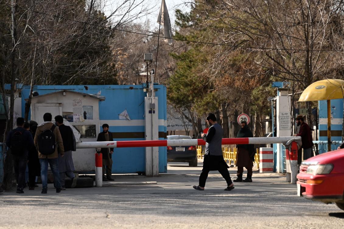Taliban security personnel stand guard as male students arrive after the re-opening of Kabul University on March 6, 2023 following a winter break. (AFP)
