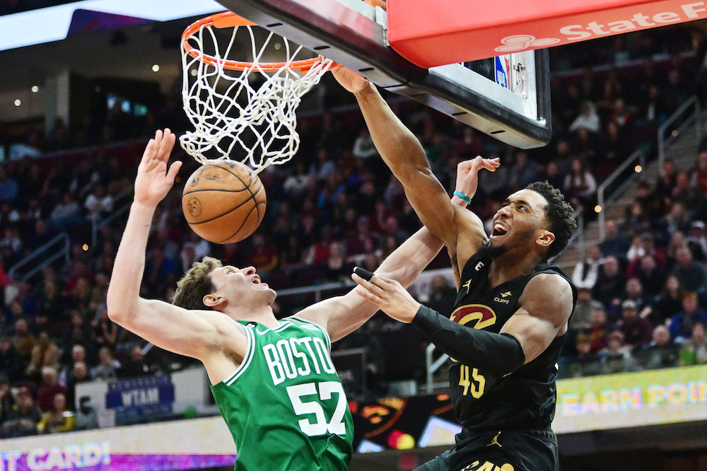 Cleveland Cavaliers guard Donovan Mitchell dunks over Boston Celtics center Mike Muscala during overtime of an NBA game at Rocket Mortgage FieldHouse. on Monday. (USA TODAY Sports)