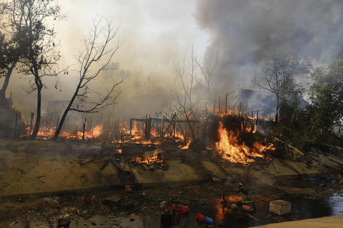 Rohingya refugees try to salvage their belongings after a major fire in their Balukhali camp at Ukhiya in Cox's Bazar district, Bangladesh, Sunday, March 5, 2023. (AP Photo/Mahmud Hossain Opu)