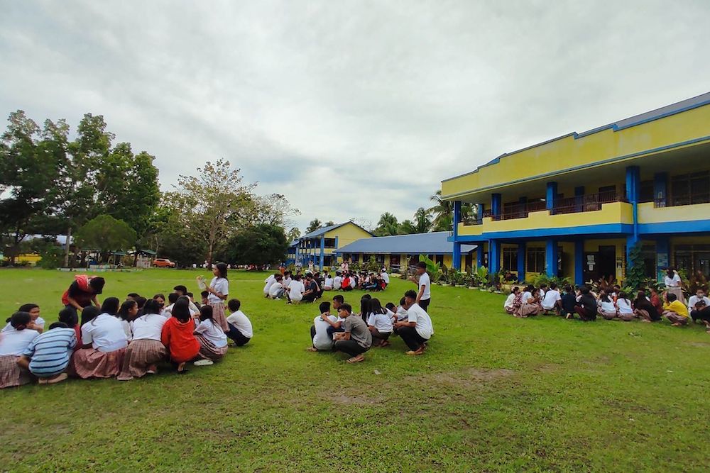 Students gather outside Buso National High School in Mati after a 6.0-magnitude earthquake jolted the southern Philippines. (Buso National High School/AFP)