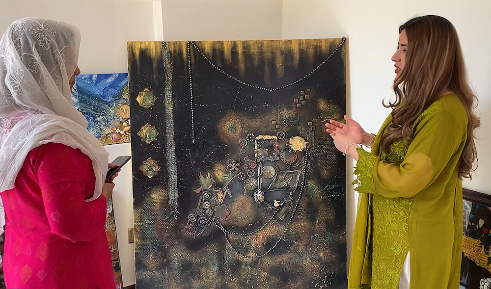 Pakistani artist Shaira Ariz, right, displays her painting at her residence in Karachi in March 2023. (AN Photo)