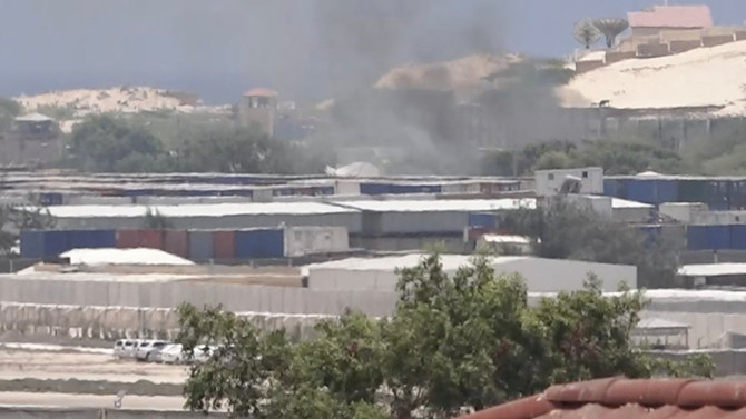 Smoke rises from behind buildings, in Mogadishu, in this still image obtained from a social media video in March 2022. On Tuesday, Al-Shabaab militants attacked a military base in a Somali town recently recaptured from the extremists, killing several soldiers. (Reuters/File)