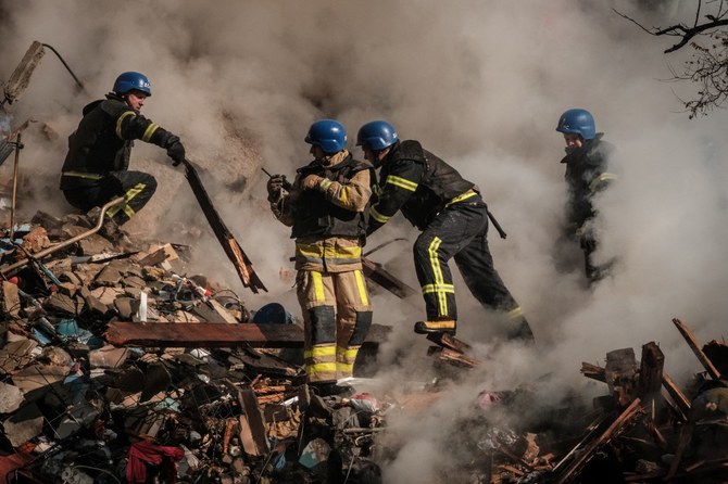 Ukrainian firefighters work on a destroyed building in Kyiv after a Russian attack with Iranian drones. (File/AFP)