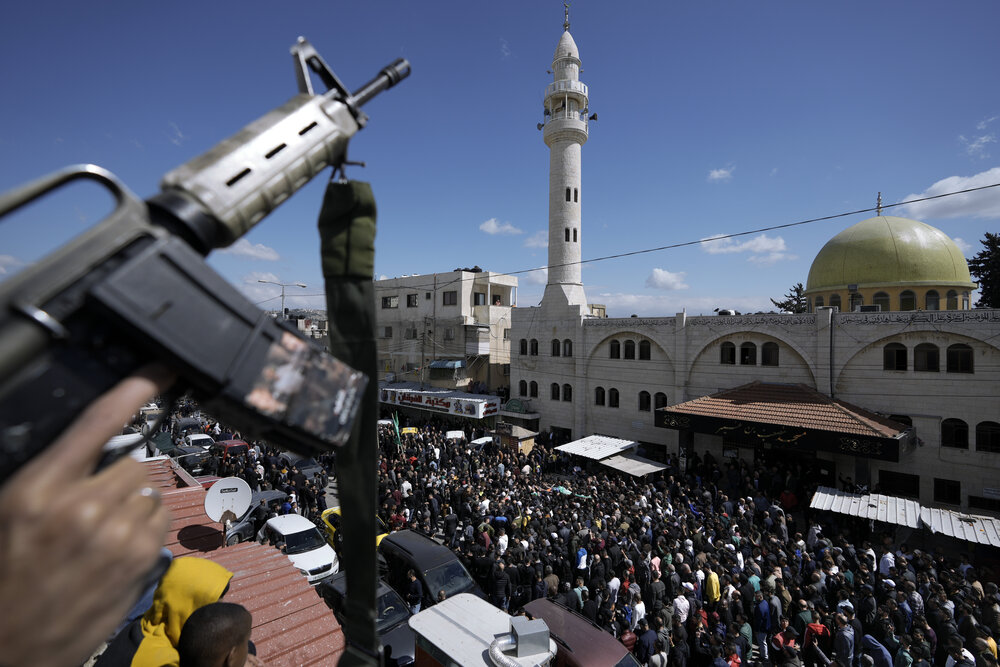 Palestinians carry the body of Abdul Fattah Kharushah, draped in the Hamas flag during his funeral in the West Bank city of Nablus on Mar. 8, 2023. (AP)