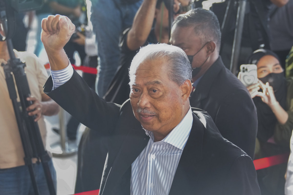 Malaysia's former Prime Minister Muhyiddin Yassin waves as he arrives at courthouse for a corruption charges in Kuala Lumpur on March 10, 2023. (AP)